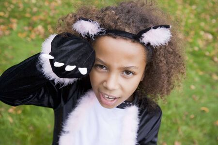 Young girl outdoors in cat costume on の写真素材