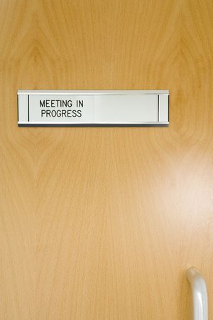 A Closed Office Door, With 'Meeting In Progress' Signの写真素材