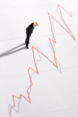 Figurine Of A Businessman Standing On A Line Graphの写真素材