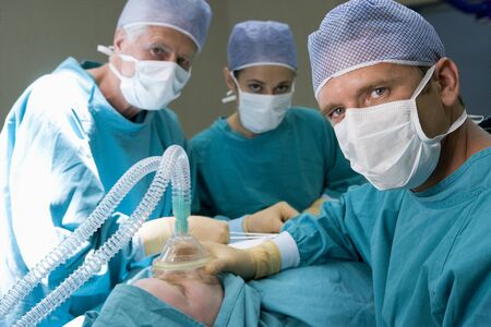 Three Surgeons Operating On A Patientの写真素材