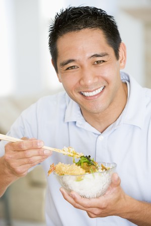 Man Enjoying Chinese Food With Chopsticksの写真素材