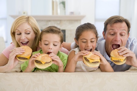 Family Eating Cheeseburgers Togetherの写真素材