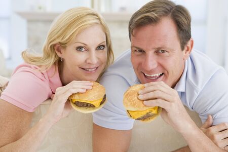 Couple Enjoying Burgers Togetherの写真素材