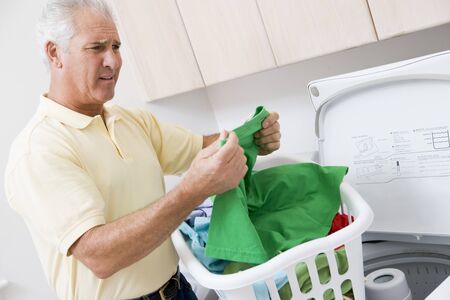 Man Reading Washing Instructionsの写真素材