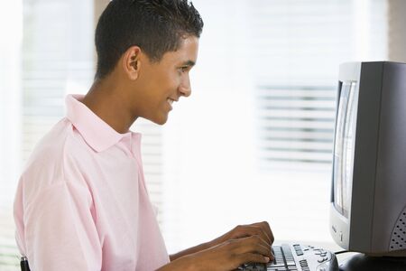 Teenage Boy Using Desktop Computerの写真素材