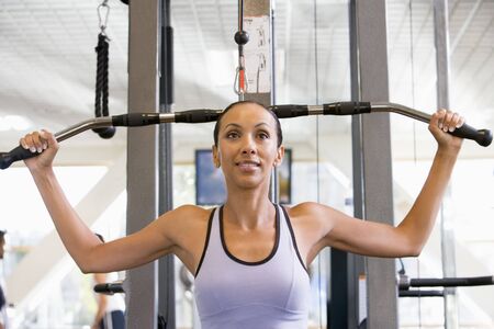 Woman Weight Training At Gym