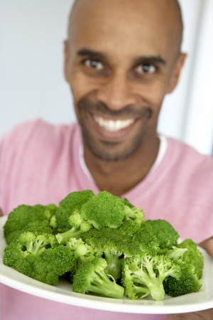 Middle Aged Man Holding A Plate Of Broccoliの写真素材