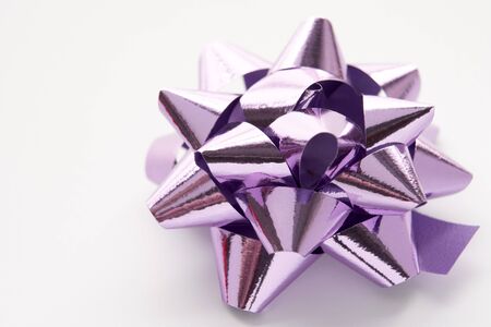 Purple Gift Wrap Bow Against White Backgroundの写真素材