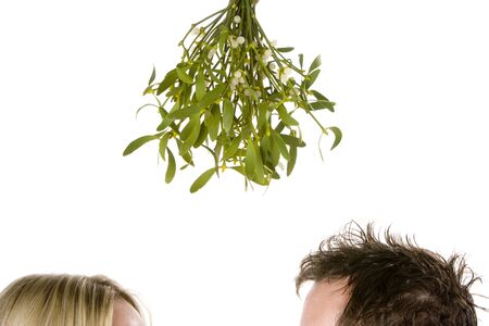 Detail Of Couple Standing Beneath Bunch Of Mistletoeの写真素材