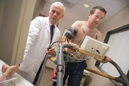 Doctor Monitoring Patient During Health Checkの写真素材