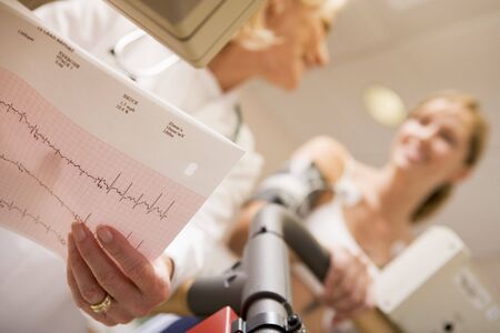 Doctor Monitoring The Heart-Rate Of Patient On A Treadmillの写真素材