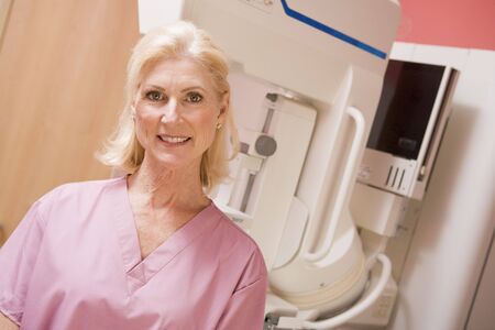 Portrait Of A Nurse In Front Of A Mammogram Machineの写真素材