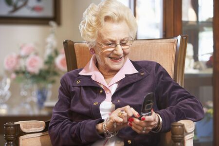 Senior woman text messaging