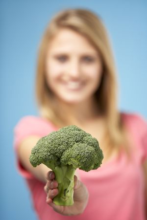 Teenage Girl Holding Fresh Broccoliの写真素材
