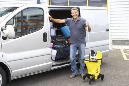 Cleaner standing next to vanの写真素材