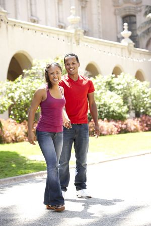 Young Couple Walking Through City Streetの写真素材
