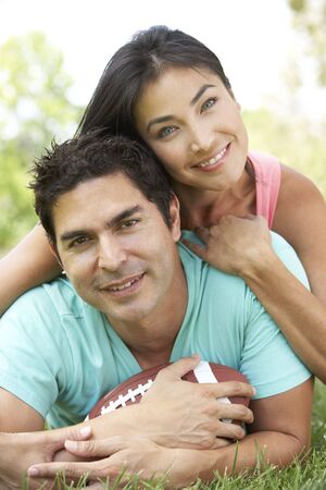 Couple In Park With American Footballの写真素材