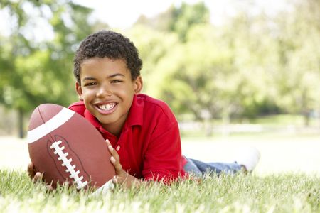 Boy In Park With American Footballの写真素材