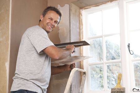Plasterer Working On Interior Wallの写真素材