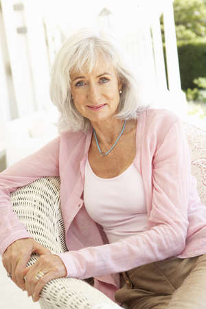 Portrait Of Senior Woman Relaxing In Chair