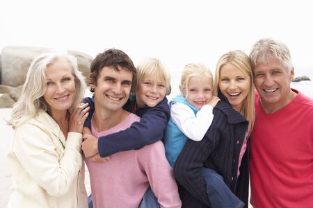 Close Up Of Three Generation Family On Winter Beach