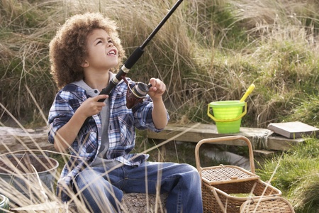 Young Boy Fishing At Seasideの写真素材