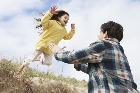 Father And Daughter Having Fun On Beach Togetherの写真素材