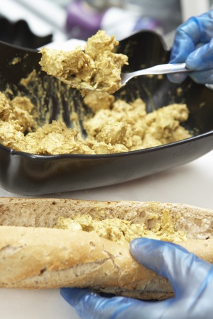 Close Up Of Hands Preparing Sandwich In Caféの写真素材