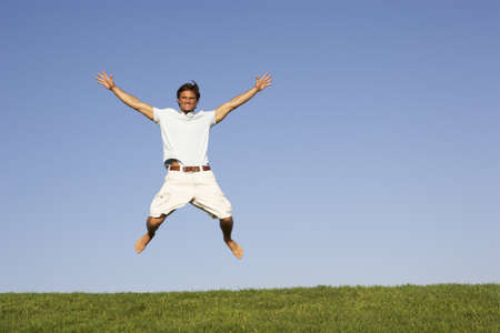 Young man jumping in airの写真素材