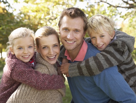 Young family pose in parkの写真素材