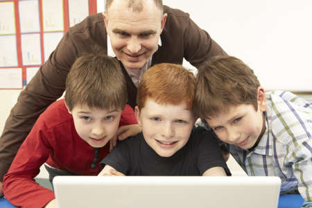 Group Of Schoolboys In IT Class Using Computerの写真素材