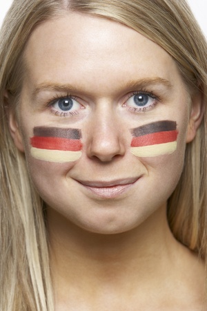 Young Female Sports Fan With German Flag Painted On Faceの写真素材