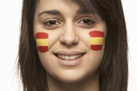 Young Female Sports Fan With Spanish Flag Painted On Faceの写真素材