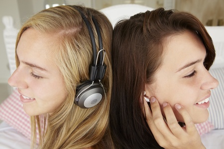 Teenage girls listening to musicの写真素材