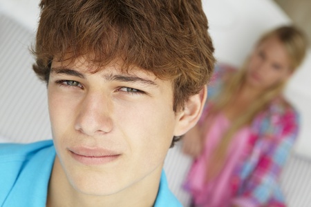 Teenage boy and girl in bedroomの写真素材