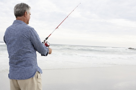 Senior man fishing in seaの写真素材