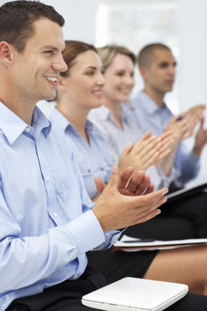 Group applauding business presentation