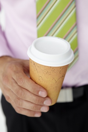 Businessman holding takeout coffeeの写真素材