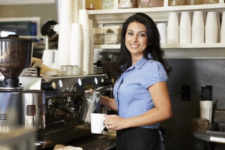 Woman working in coffee shopの写真素材