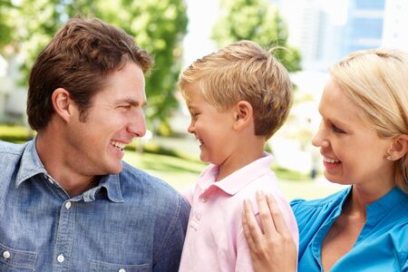 Couple in city park with young sonの写真素材