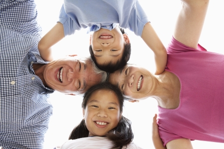 Chinese Grandparents With Grandchildren Looking Down Into Cameraの写真素材