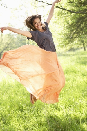 Woman Jumping In Summer Fieldの写真素材