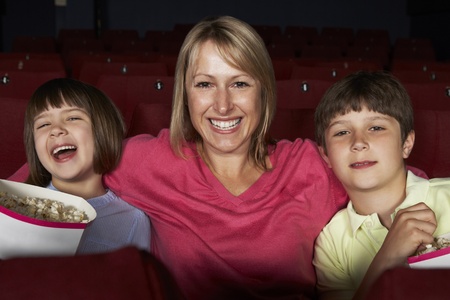 Mother Watching Film In Cinema With Two Childrenの写真素材