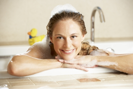Woman Relaxing In Bubble Filled Bath