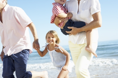 Grandparents And Grandchildren Enjoying Beach Holidayの写真素材