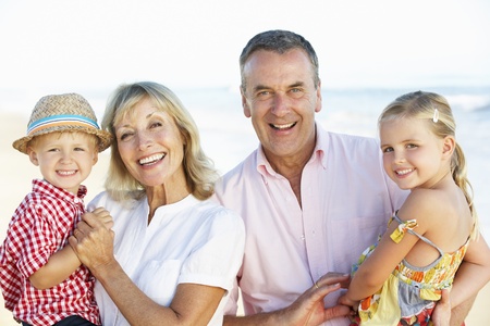 Grandparents And Grandchildren Enjoying Beach Holiday