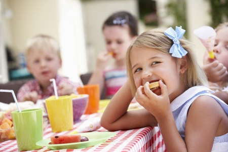 Group Of Children Enjoying Outdoor Tea Partyの写真素材