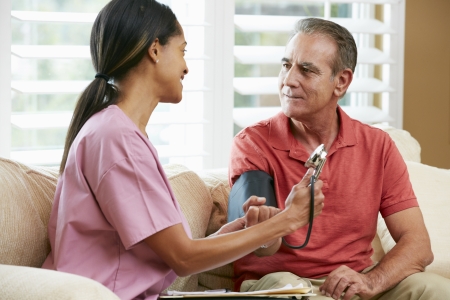 Nurse Visiting Senior Male Patient At Homeの写真素材