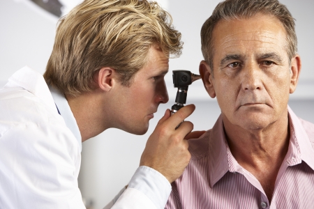 Doctor Examining Male Patient's Earsの写真素材