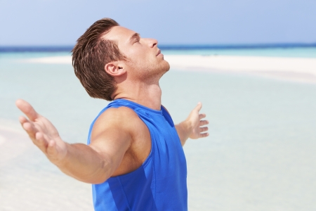 Man Meditating On Beautiful Beachの写真素材